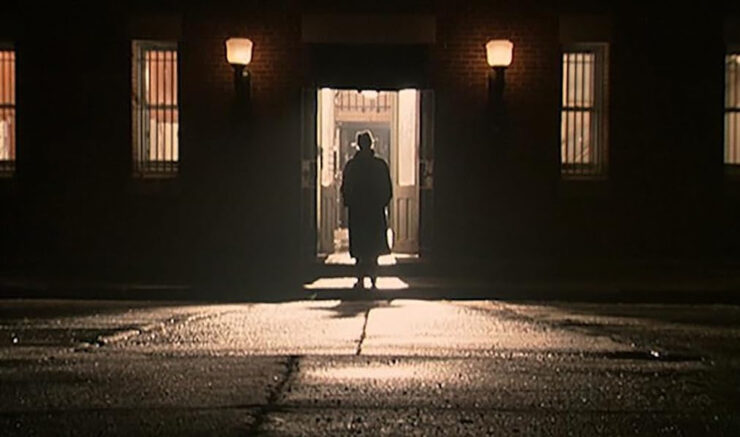 Mr. Shroud (Cliff Robertson) stands silhouetted in a doorway in the movie 13th Child