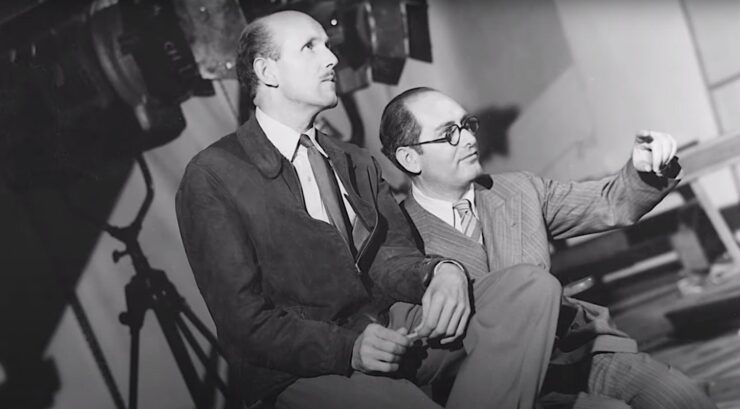 Michael Powell and Emeric Pressburger sit together on a film set in a still included in Made in England: The Films of Michael Powell and Emeric Pressburger.