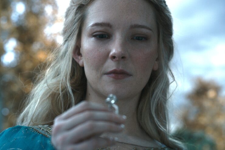 Morfydd Clark as Galadriel looking at her ring in The Rings of Power