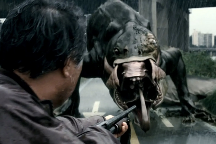 A scene from the Korean film The Host (2006): Park Hee-bong (Byun Hee-bong) points a gun at the monster.
