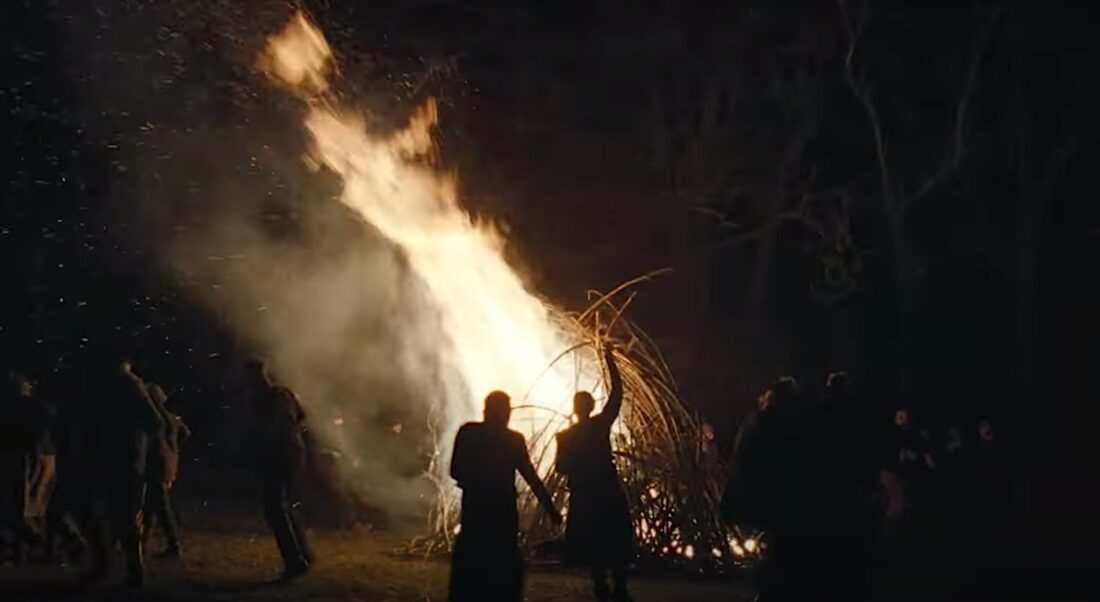 People dance around a bonfire in The Devil's Bath.
