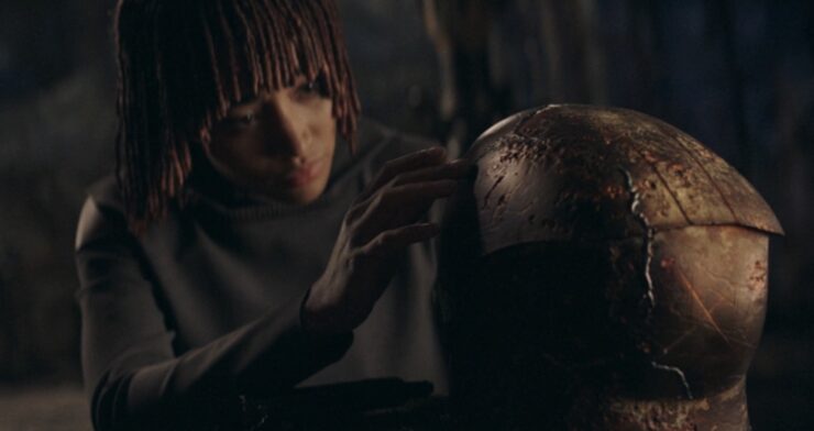 Amandla Stenberg as Osha, looking as Qimir's helmet in The Acolyte, "Teach/Corrupt"