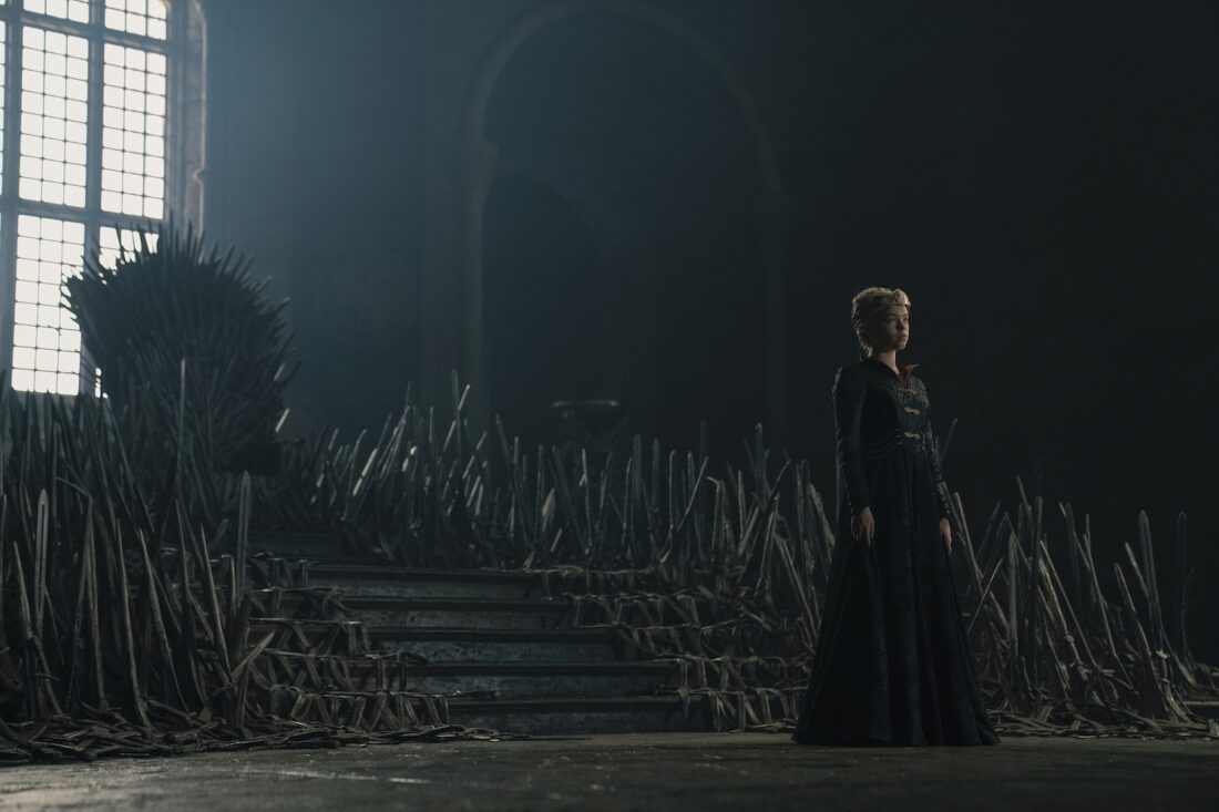 A young Rhaenyra (Milly Alcock) stands before the Iron Throne in a scene from House of the Dragon: "A Dance of Dragons"