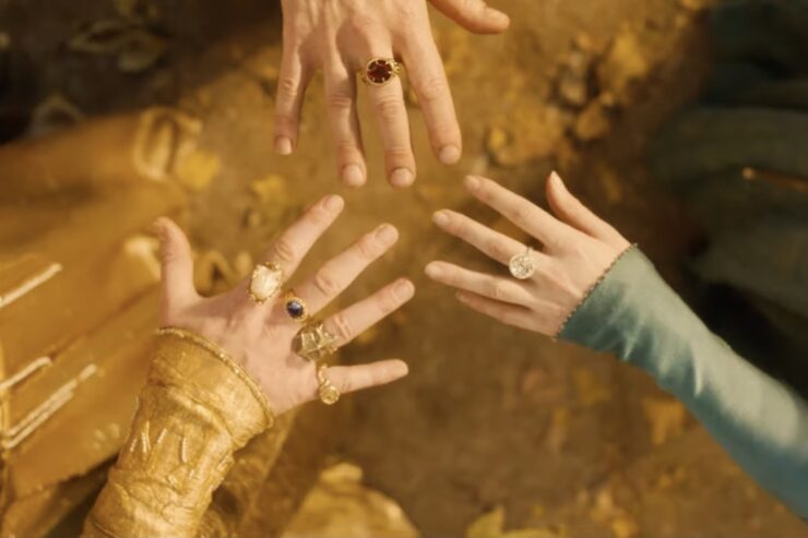 Three elven hands wearing big chonky powerful rings