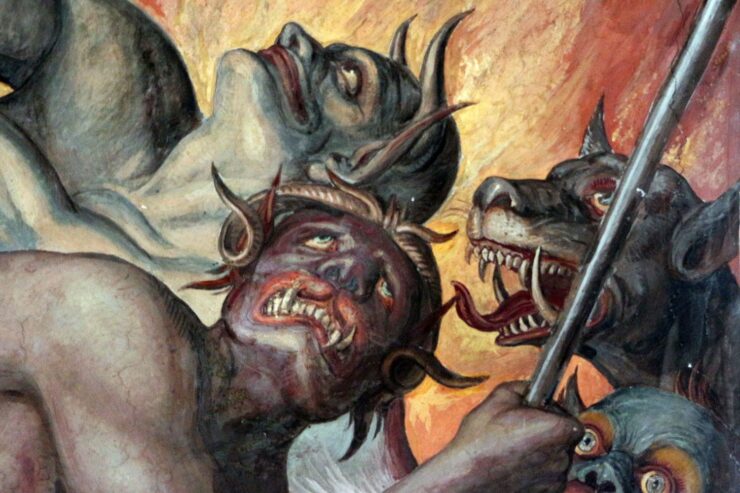 Detail from a fresco by Joseph Anton Koch depicting Dante's Inferno: close-up of three demons and a hellhound