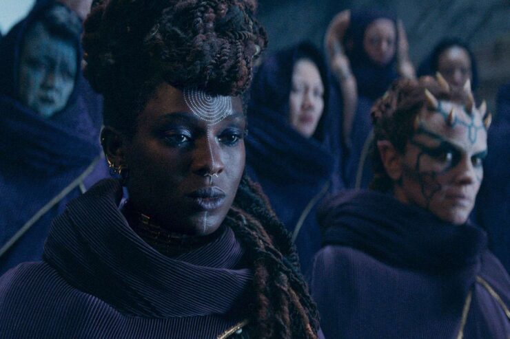 A scene from Star Wars: The Acolyte; Mother Aniseya (Jodie Turner-Smith) and Koril (Margarita Levieva) stand with the rest of the coven.