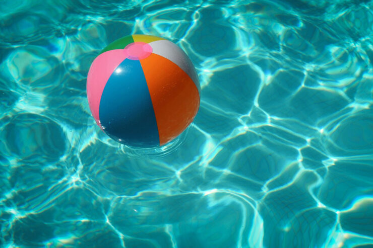 multi-colored beach ball floating in a pool