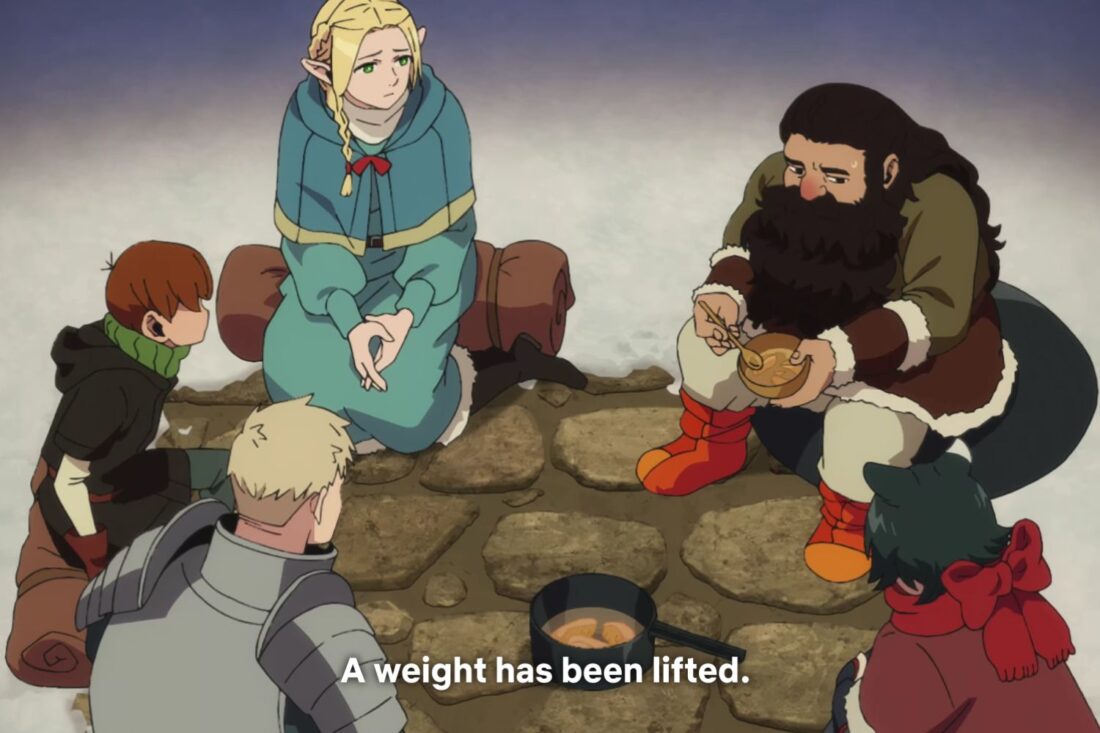 A scene from Delicious in Dungeon: Laios, Chilchuck, Marcille, Senshi, and Itzumi sit in a circle around a cooking pot. The caption reads "A weight has been lifted."