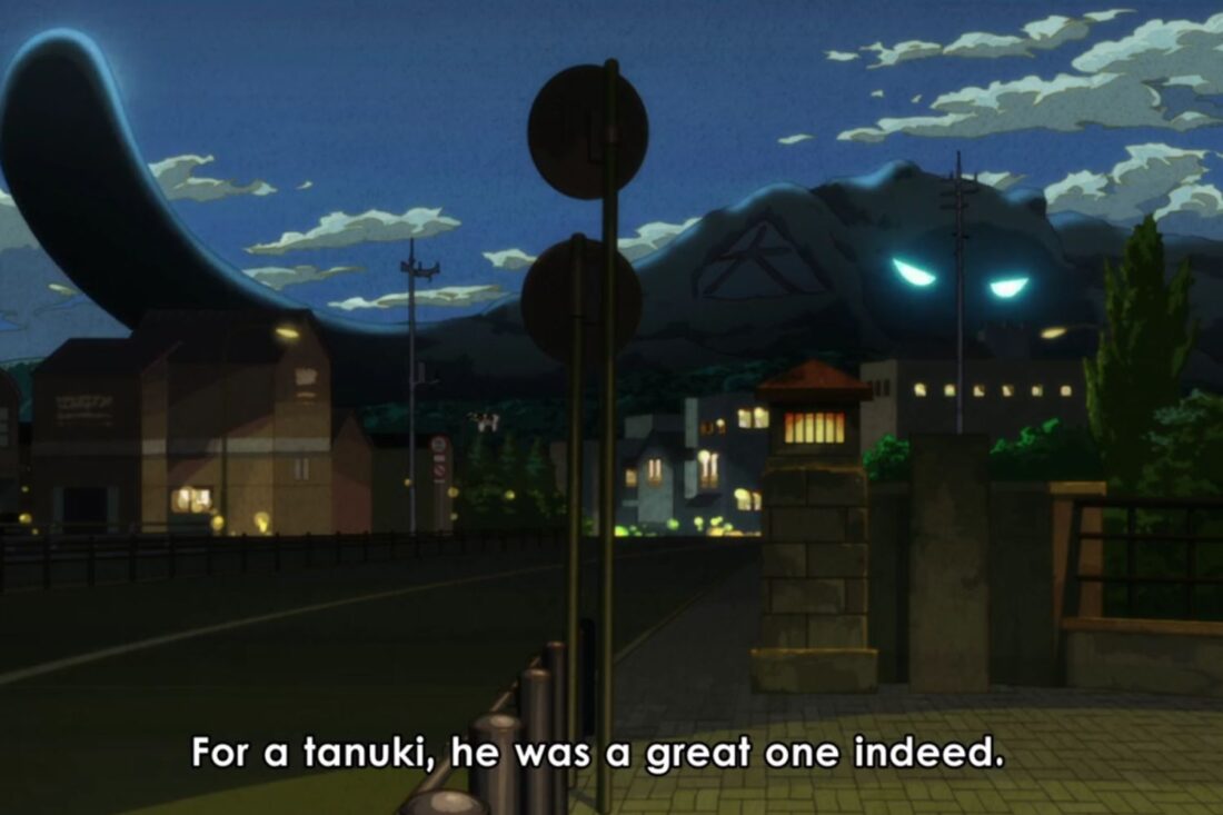 A scene of a street view from the anime series The Eccentric Family. The subtitles read: "For a tanuki, he was a great one indeed."