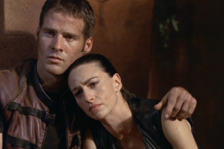 John (Ben Browder) and Aeryn (Claudia Black) lean together in a scene from Farscape.