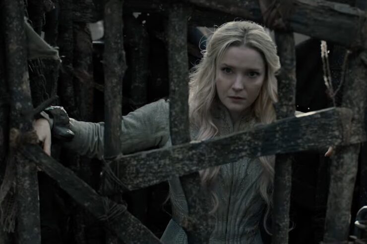 Morfydd Clark in The Lord of the Rings: The Rings of Power standing in a cage