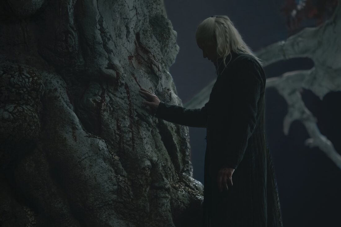 A scene from House of the Dragon season 2 episode 8: Daemon (Matt Smith) touches a weirwood tree