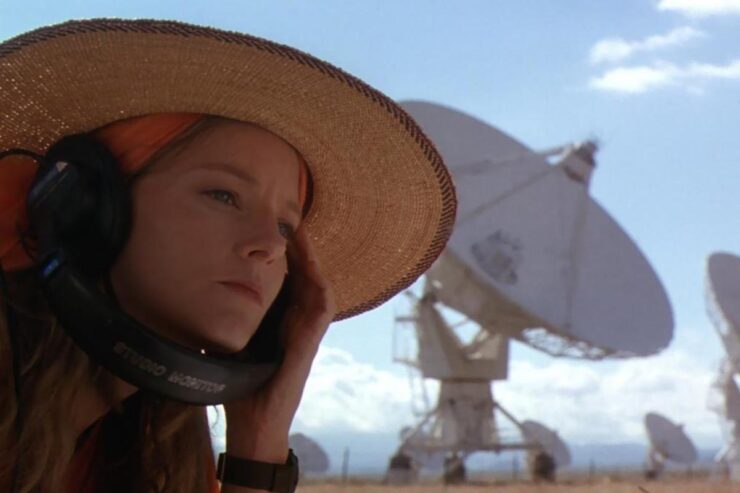 Image from Contact (1997): Dr Ellie Arroway (Jodie Foster) listens to headphones in front of the Very Large Array Radio Telescope