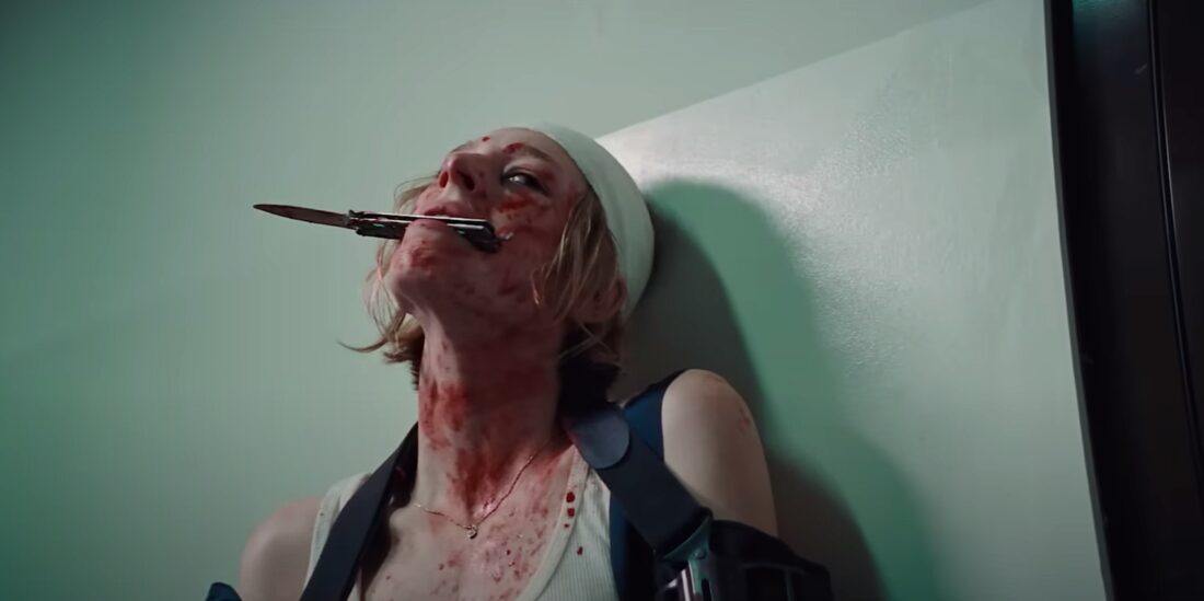 Gretchen (Hunter Schafer) holds a knife in her teeth between battles in Tilman Singer's Cuckoo.