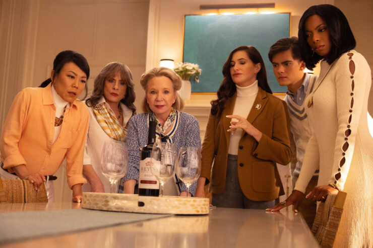 (L-R): Alice Wu-Gulliver (Ali Ahn), Lilia Calderu (Patti LuPone), Mrs. Hart/Sharon Davis (Debra Jo Rupp), Agatha Harkness (Kathryn Hahn), Teen (Joe Locke) and Jennifer Kale (Sasheer Zamata) surrounding a bottle of wine and glasses in Marvel Television's AGATHA ALL ALONG