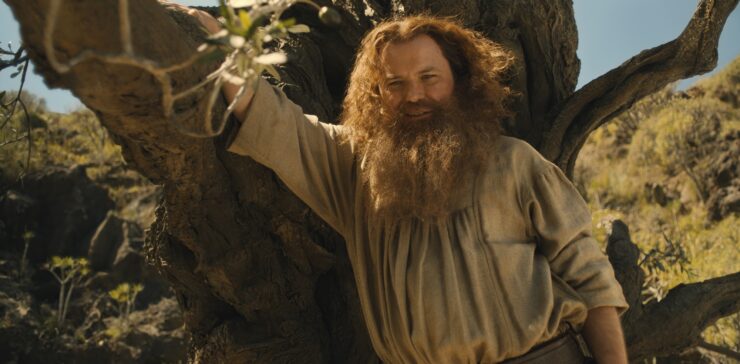 Rory Kinnear as Tom Bombadil leaning on a tree in Rings of Power, "Eldest"