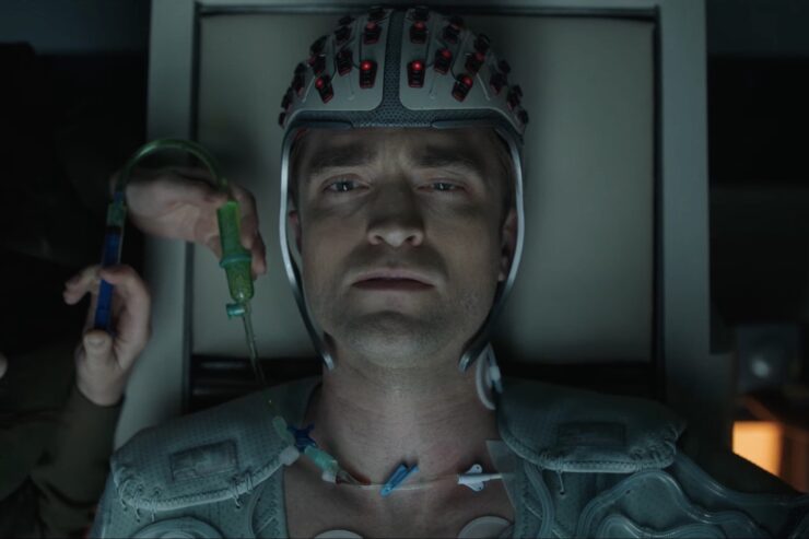 Robert Pattinson strapped down with a device on his head in Mickey 17