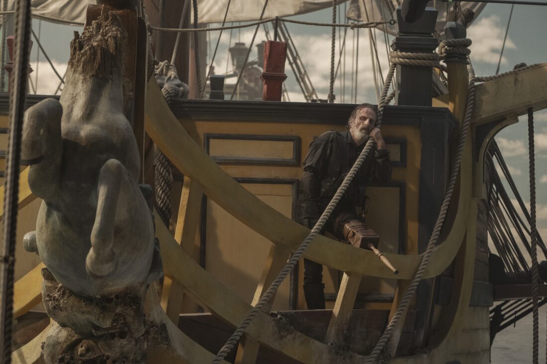 Izzy Hands (Con O'Neill) drunken and depressed, sitting behind the unicorn figurehead of the ship in Our Flag Means Death S2