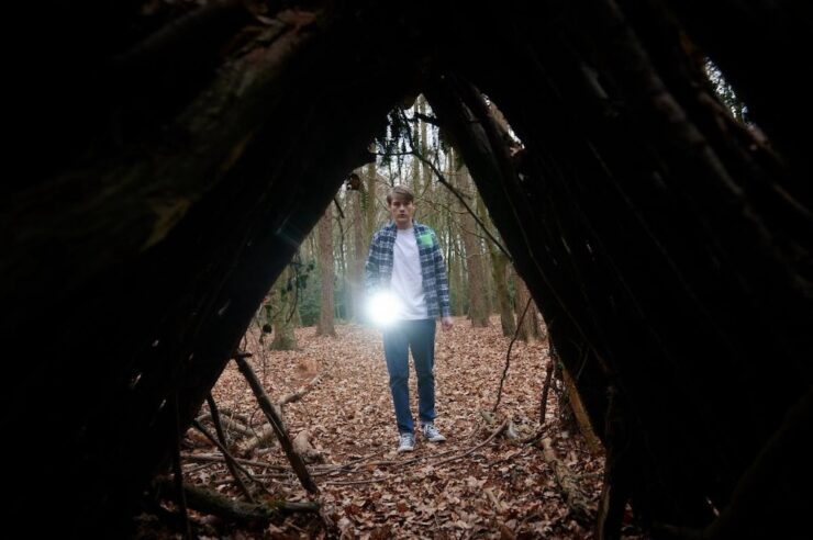 Boy looking at spooky thing in woods in Daddy's Head