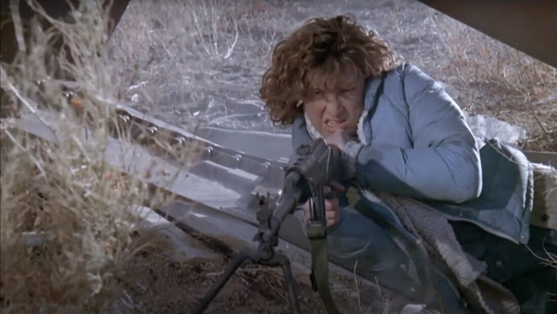 Toni Mason (Jennifer Grey) uses a machine gun against the invaders in John Milius' Red Dawn.