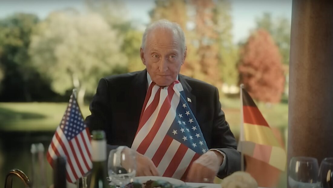 Edison Wolcott, the President of the United States (Charles Dance) adjusts his patriotic bib in Rumours.