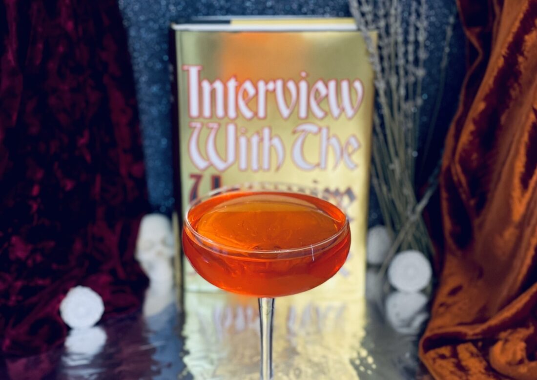 Photo of Anne Rice's Interview with the Vampire and a cocktail inspired by the book.