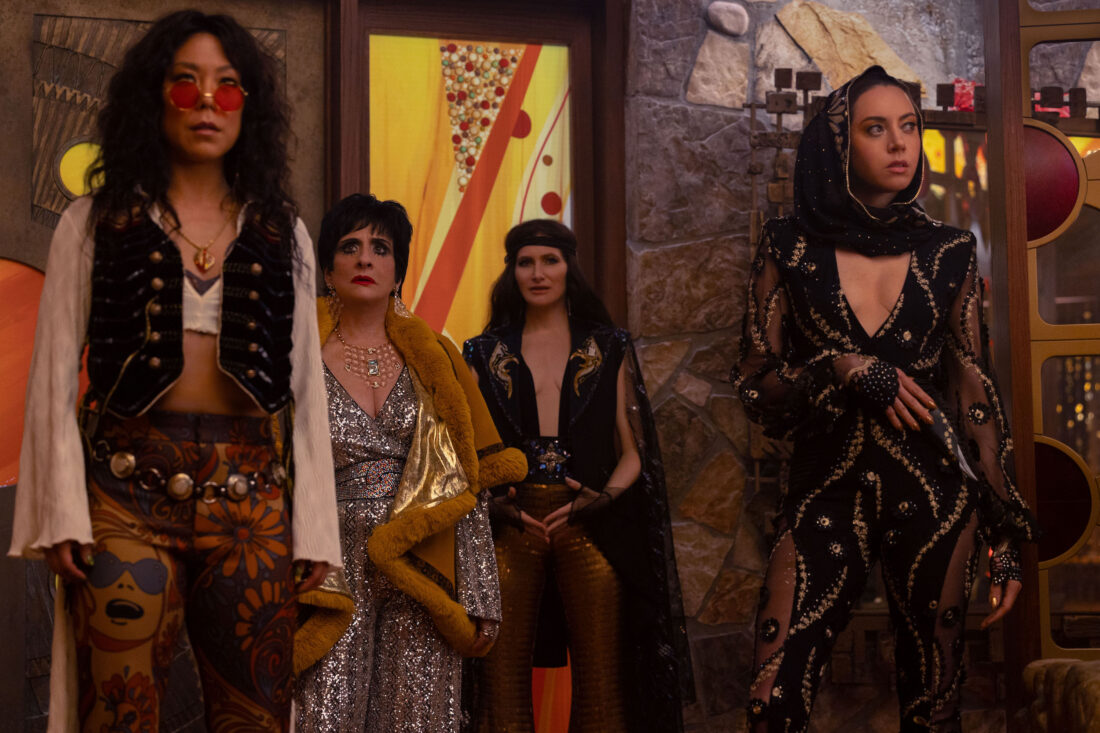 (L-R) Alice Wu-Gulliver (Ali Ahn), Lilia Calderu (Patti LuPone), Agatha Harkness (Kathryn Hahn) and Rio Vidal (Aubrey Plaza) in '70s finery, looking around a new house in Agatha All Along, "If I Can't Reach You / Let My Song Teach You"