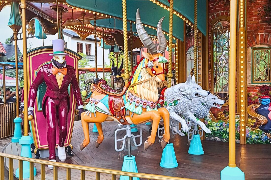 Photo of a carousel at Ghibli Park, including figures of Yakul and several wolves from Princess Mononoke, and the Witch of the Waste’s palanquin from Howl's Moving Castle