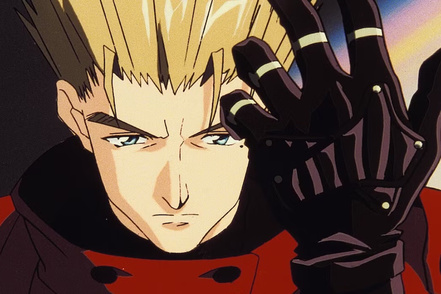 Vash holds up a gloved hand in a scene from Trigun