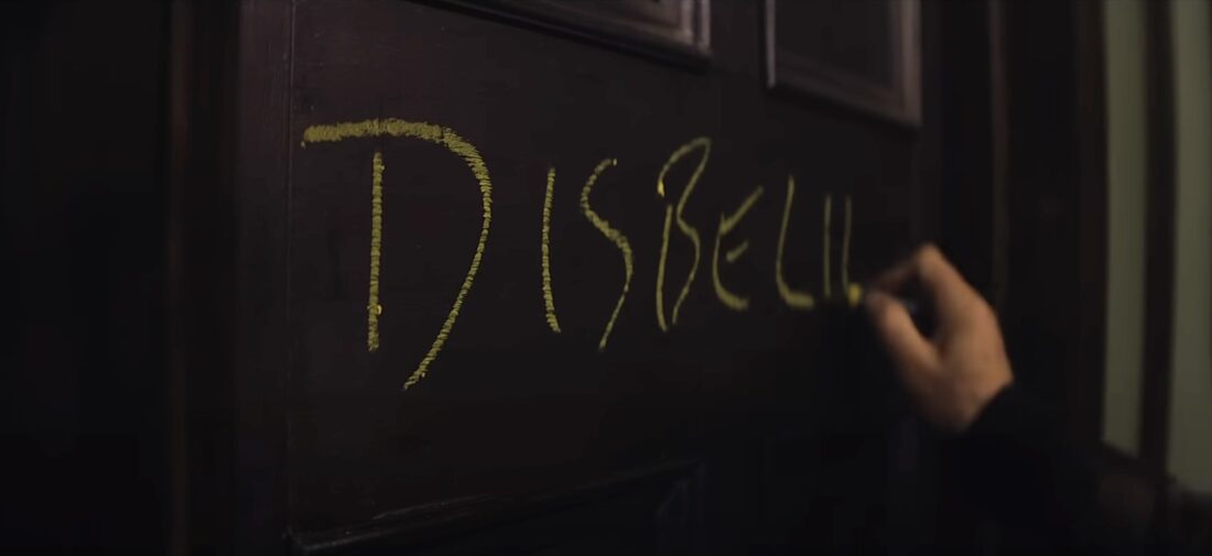 Mr. Reed writes the word "Disbelief" on a door in Heretic.