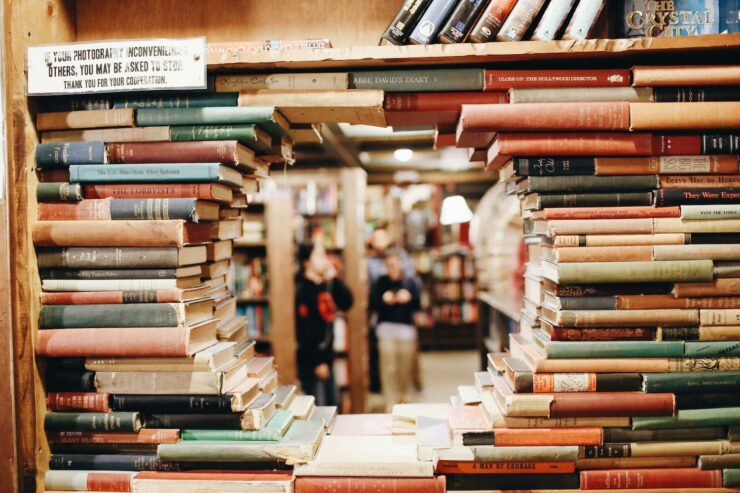 A bookstore seen through a circular gap in a bookshelf