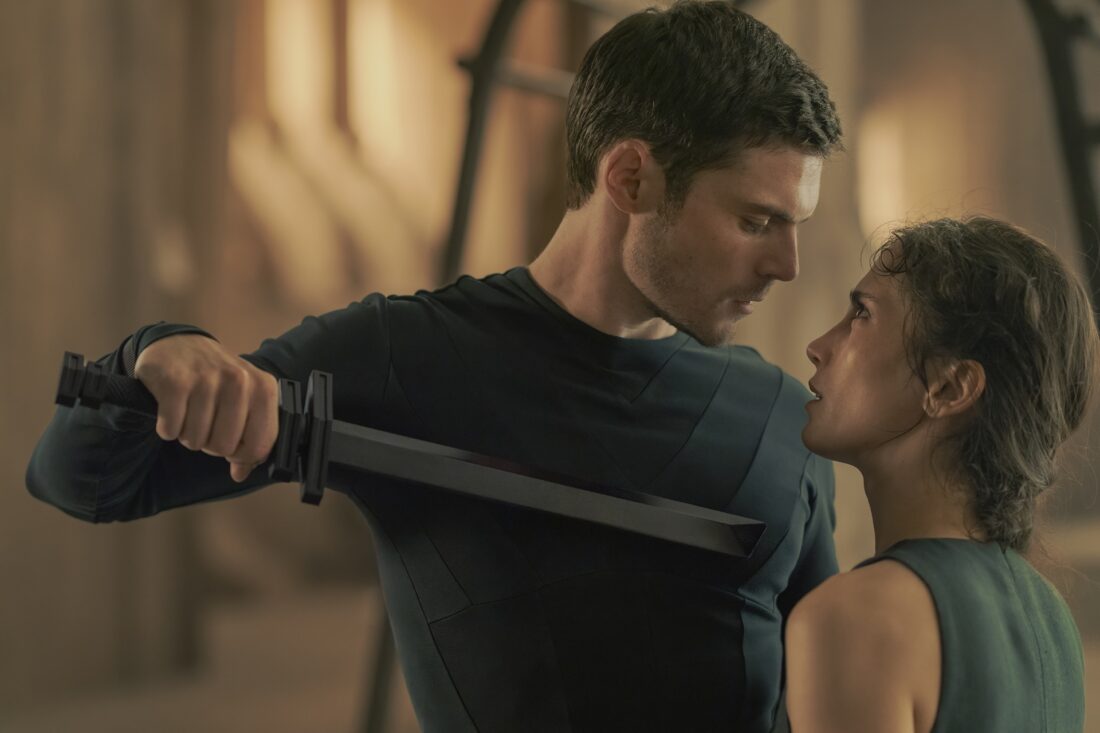 Princess Ynez (Sarah-Sofie Boussnina) with a knife sultrily held to her neck by Keiran Atreides (Chris Mason) in Dune: Prophecy episode one, The Hidden Hand