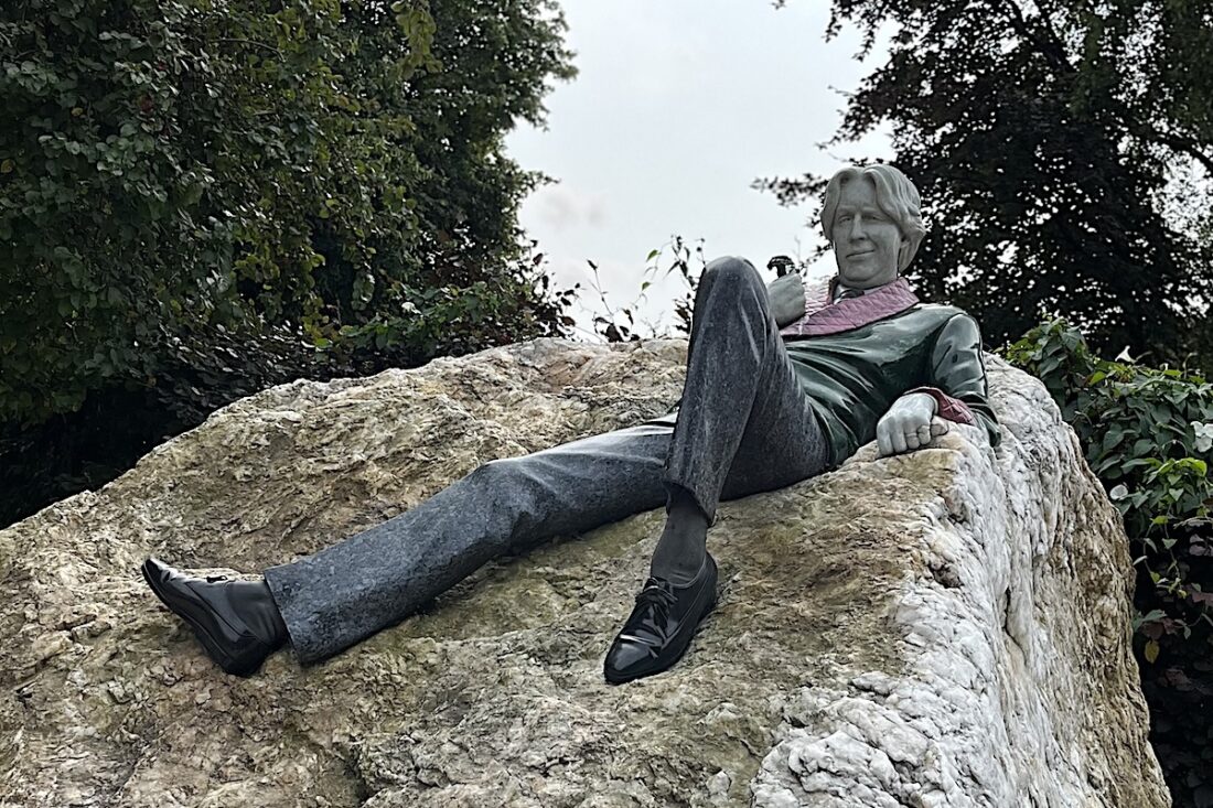 Oscar Wilde smirks at his admirers in the Oscar Wilde Memorial Statue in Dublin, Ireland.