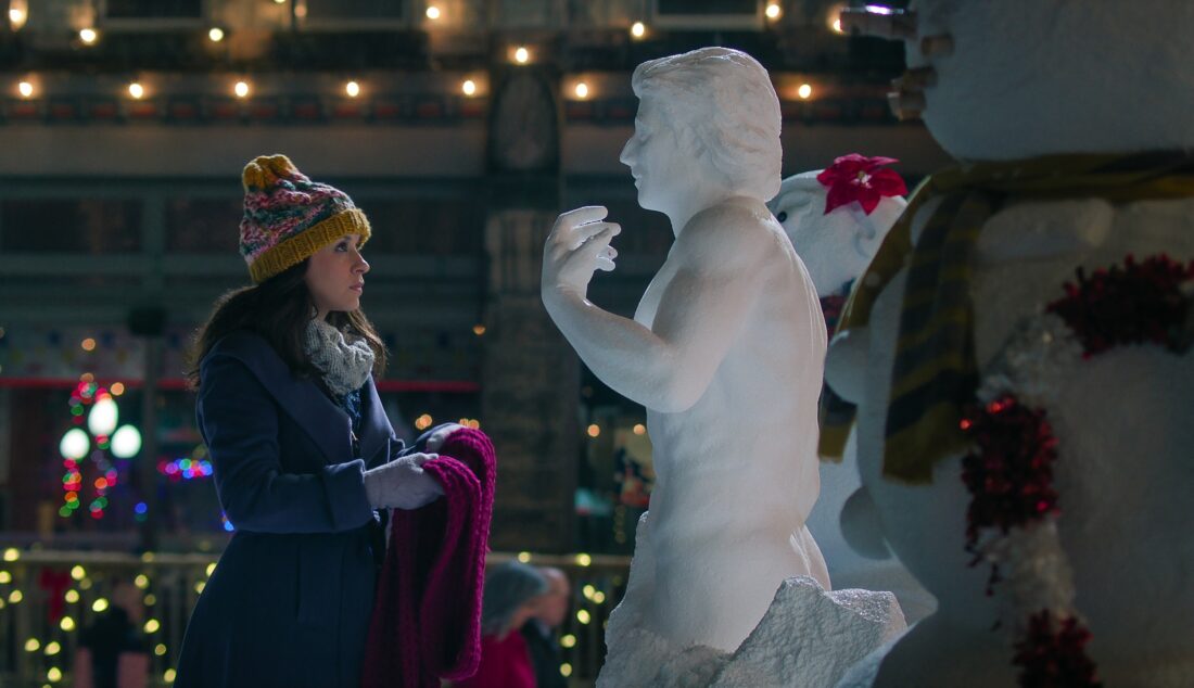 Lacey Chabert as Kathy Barrett staring at a sculpted snowman in Hot Frosty