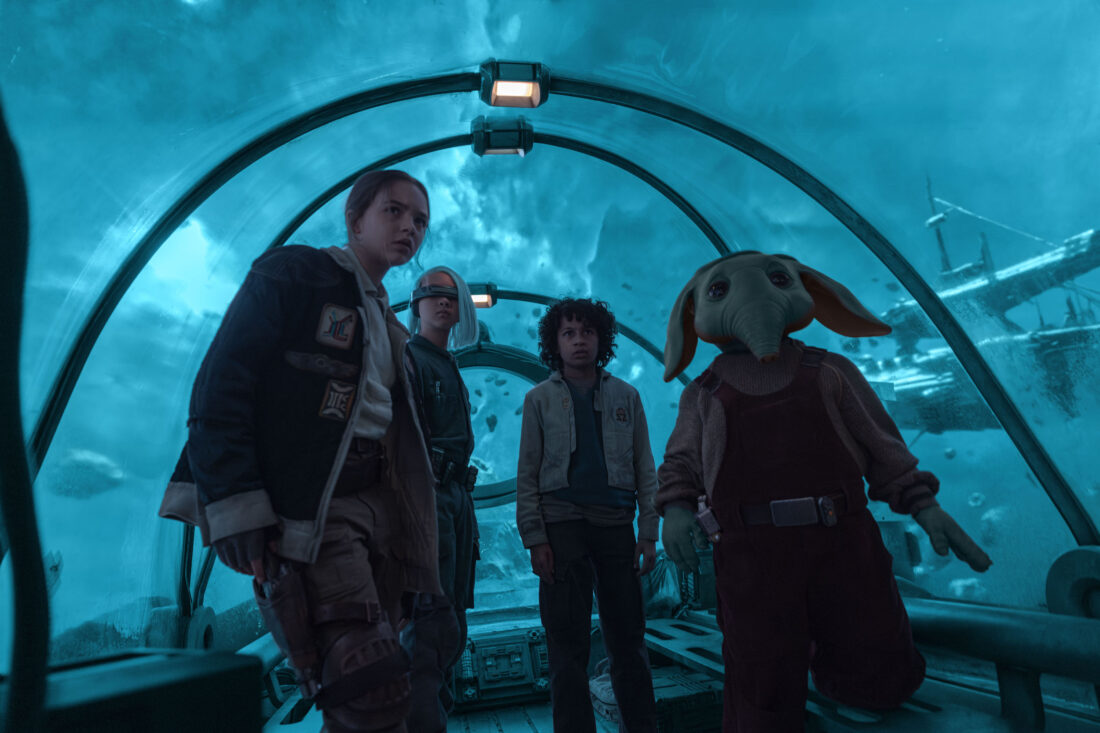 (L-R) Fern (Ryan Kiera Armstrong), KB (Kyriana Kratter), Wim (Ravi Cabot-Conyers), Neel (Robert Timothy Smith) in a ferry heading over to Port Borgo in Lucasfilm’s STAR WARS: SKELETON CREW