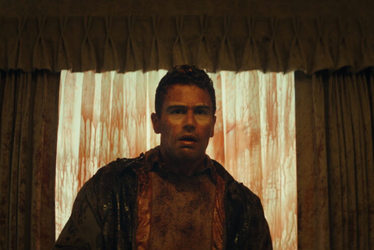 Theo James in shock with a bloodied face in The Monkey.