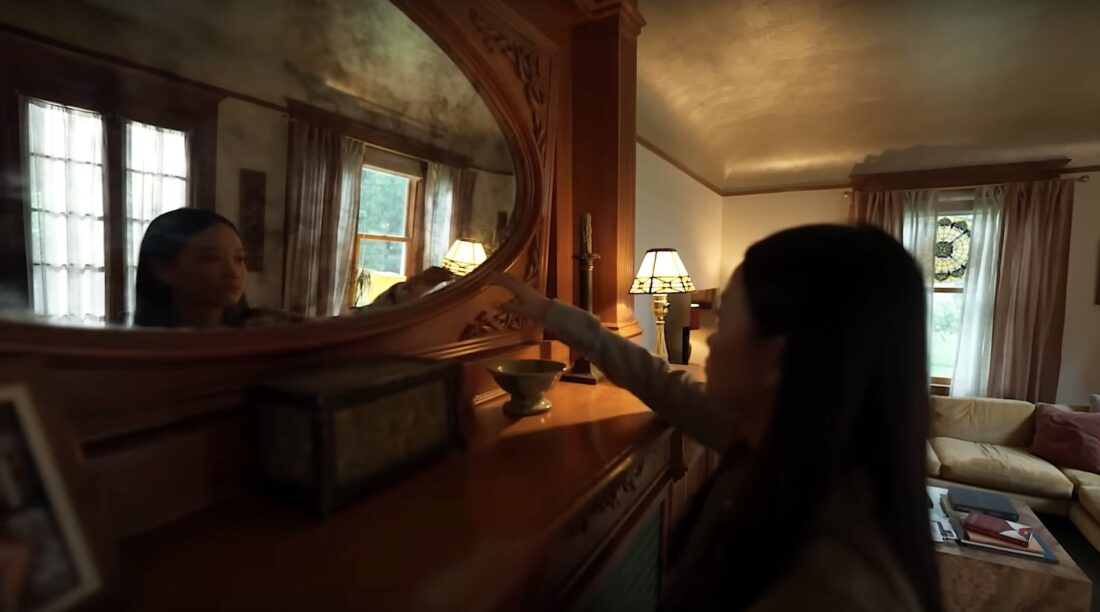 Chloe Payne (Callina Liang) reaches toward an antique silver nitrate mirror in Presence.