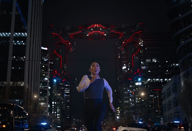 Woman running away from Tron kaiju in Tron: Ares