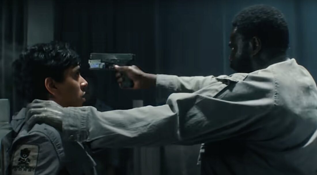 Morrow (Babou Ceesay) pulls a gun on Slightly (Adarsh Gourav) in Noah Hawley's Alien: Earth.