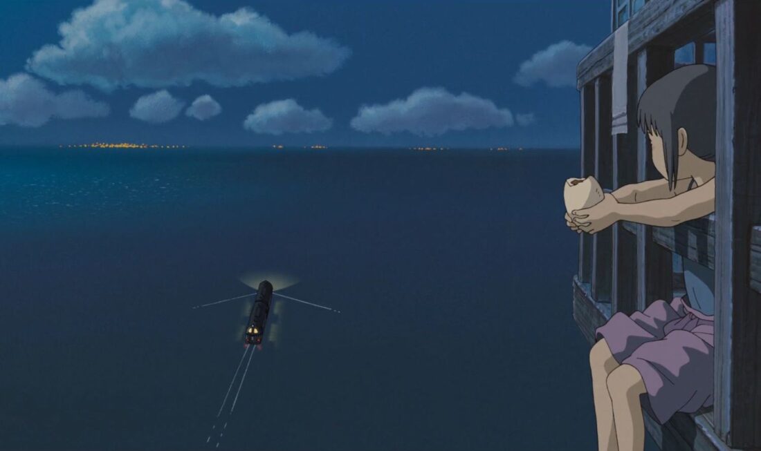 Chihiro watches a distant train in a scene from Studio Ghibli's Spirited Away