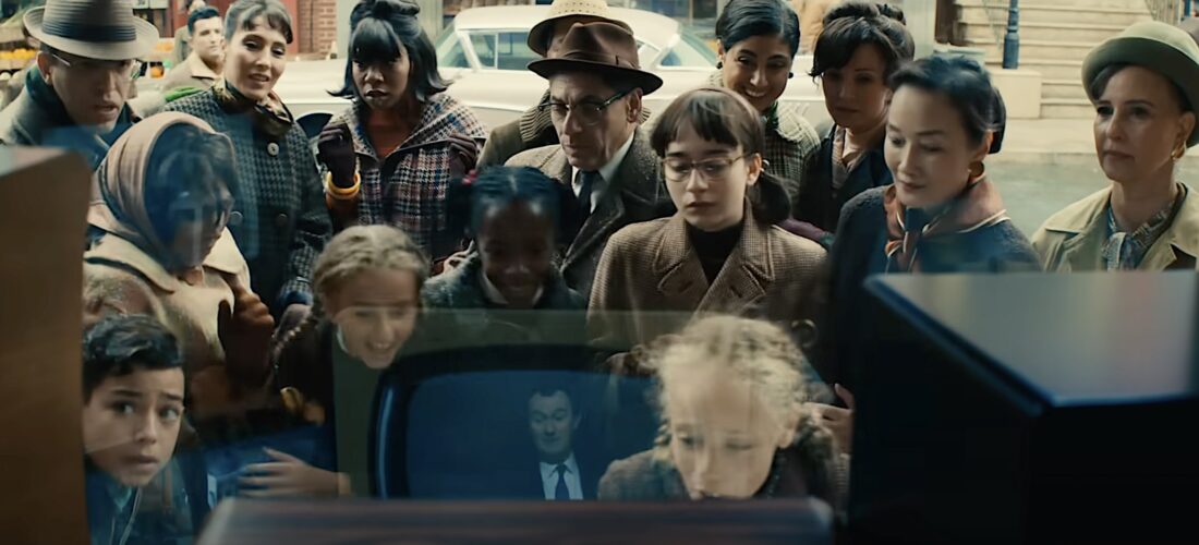 Ordinary citizens assemble in front of TV screens to watch the Fantastic Four in Fantastic Four: First Steps.