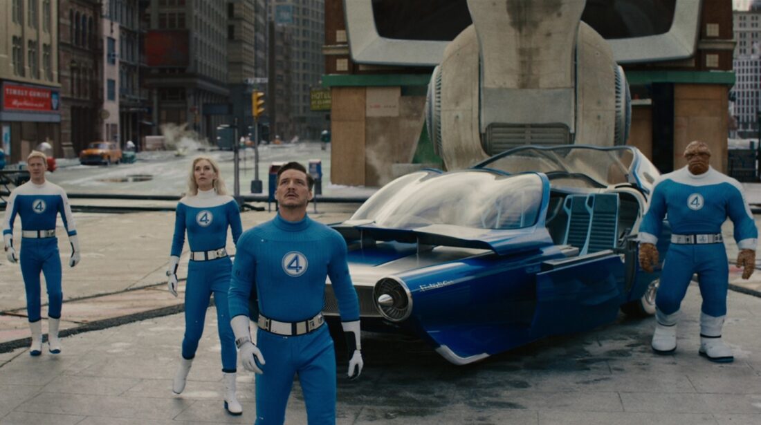 Johnny Storm, Sue Storm, Reed Richards, and Ben Grimm stand near the Fantasticar in The Fantastic Four: First Steps