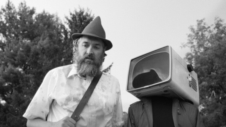 Conor and Victor (a man with a TV head) continue a quest in OBEX