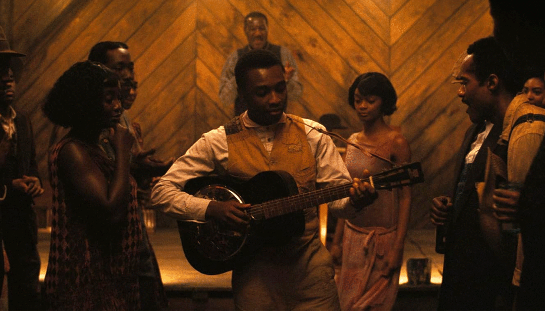 Sammie (Miles Canton) plays the guitar in Smoke and Stack's juke joint in Sinners
