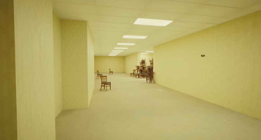 Chairs are scattered around a yellow-lit room in strange ways in a scene from Kane Parson's Backrooms.