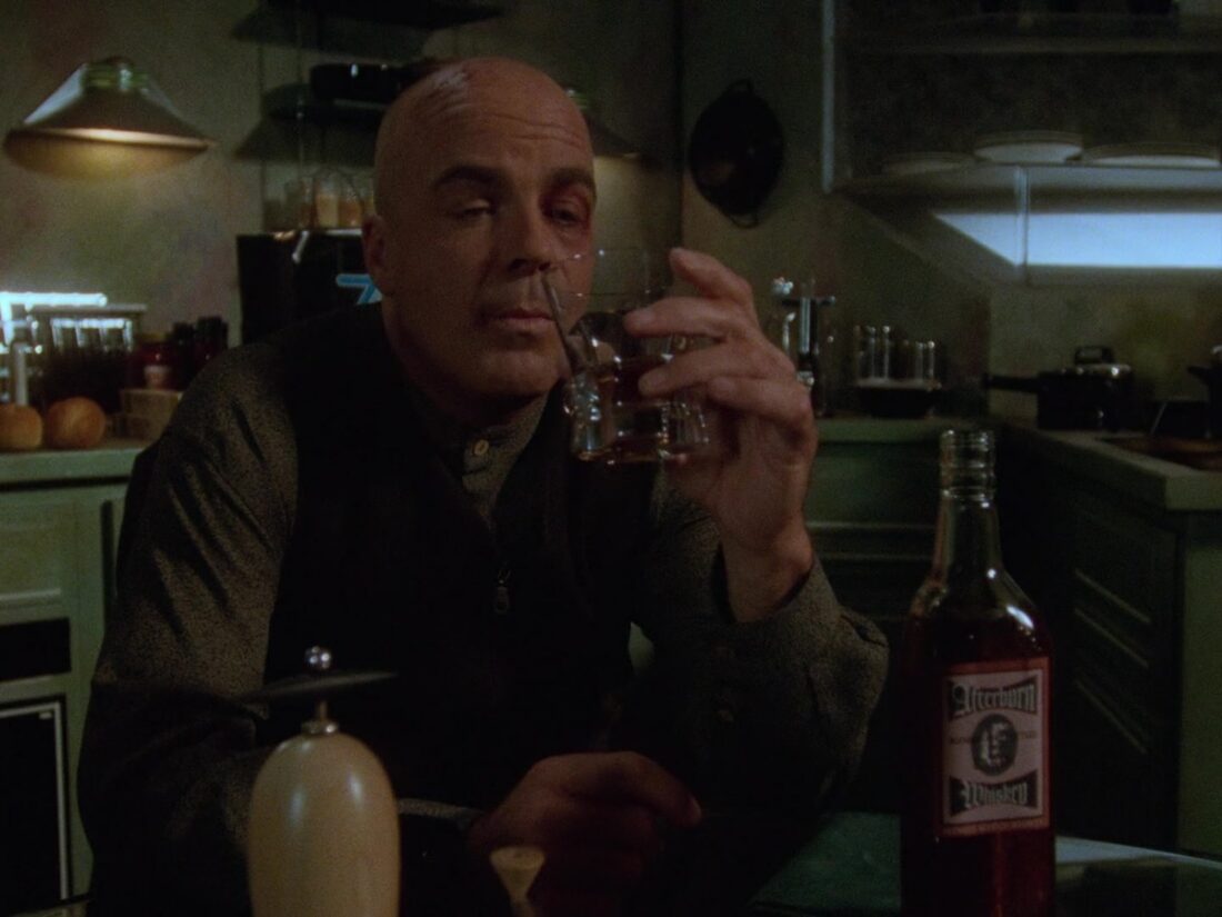 Garibaldi pours himself a drink in a scene from Babylon 5 "Phoenix Rising"