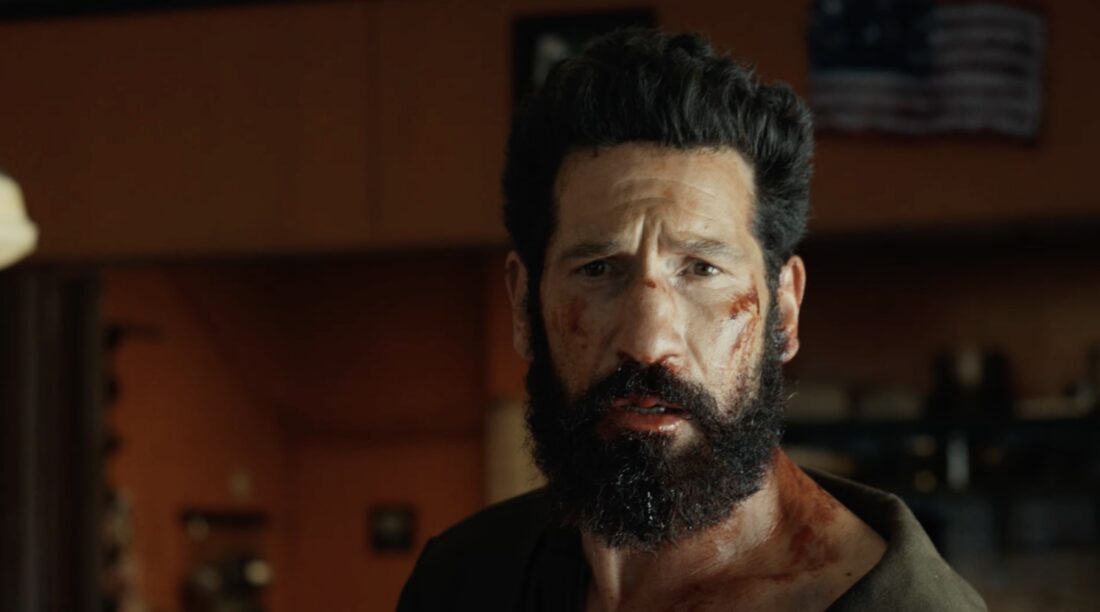 Frank Castle beaten and bloody and looking heartbroken in The Punisher: One Last Kill