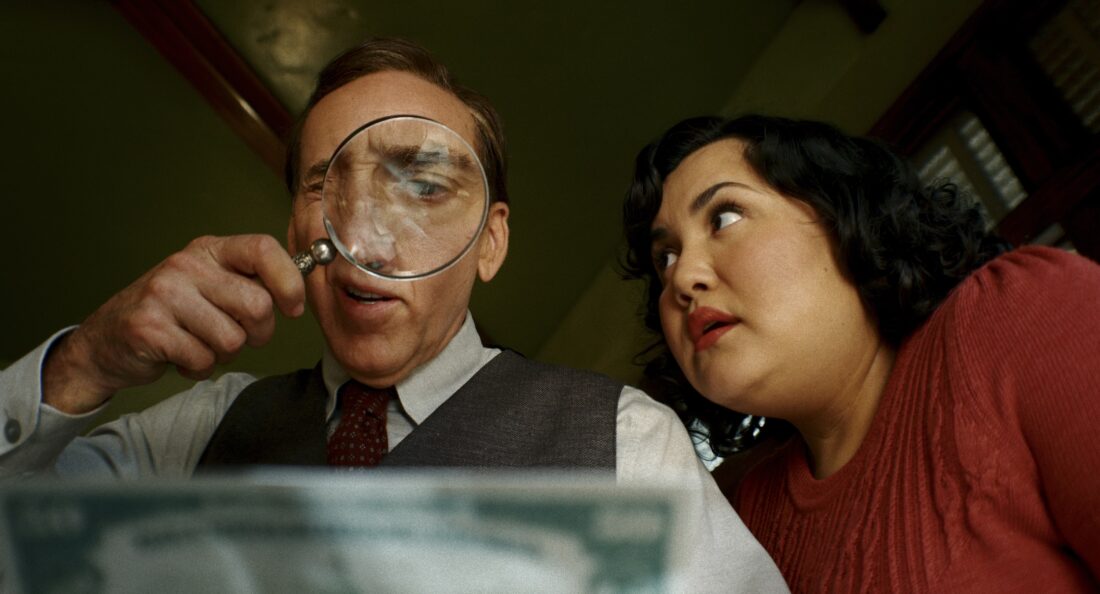 Ben Reilly looking at a newspaper under a magnifying glass while Janet Ruiz watches him in Spider-Noir S1