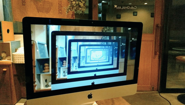 Image of a computer monitor displaying the image of infinite computer monitors, from the film Beyond the Infinite Two Minutes