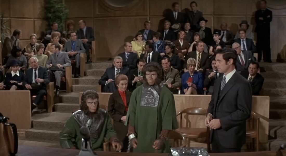 Dr. Zira and Dr. Cornelius in a hearing room full of humans in Escape From the Planet of the Apes